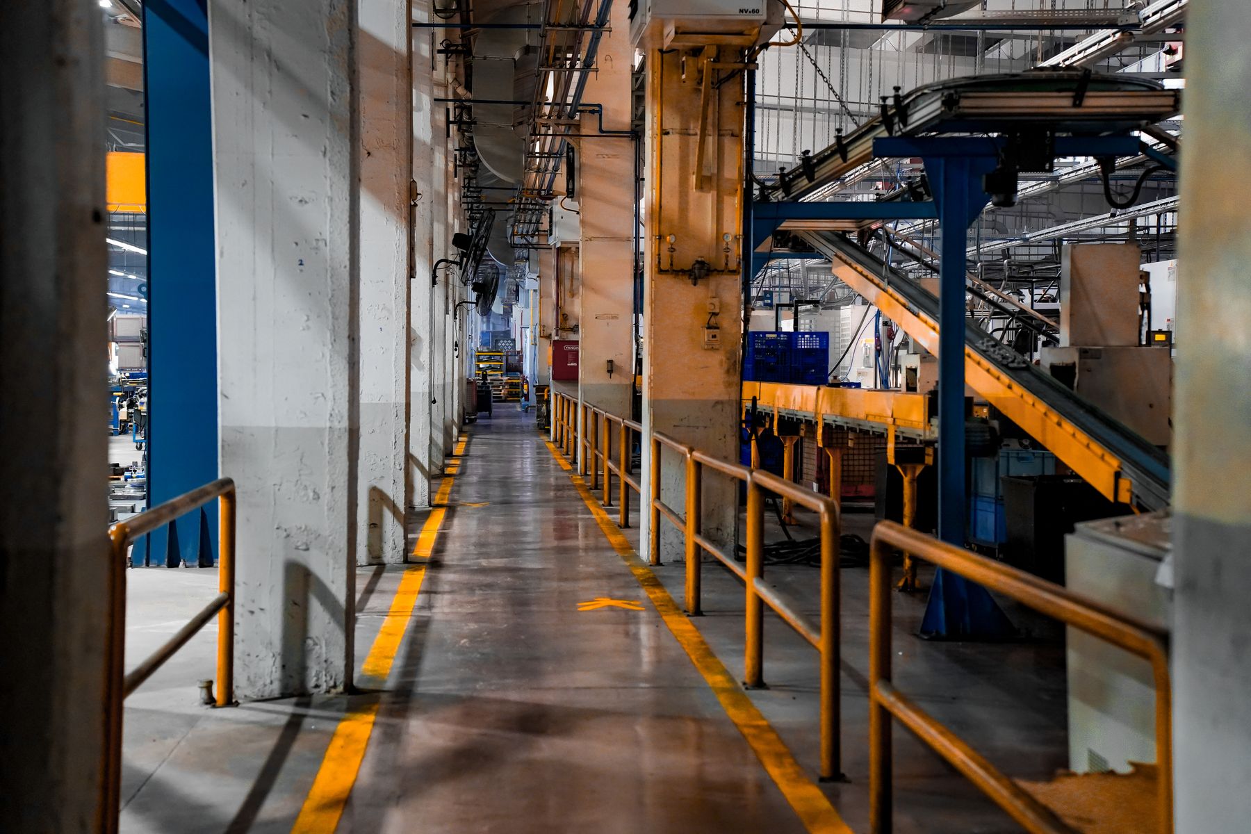 A wide view of a modern factory interior with industrial machinery