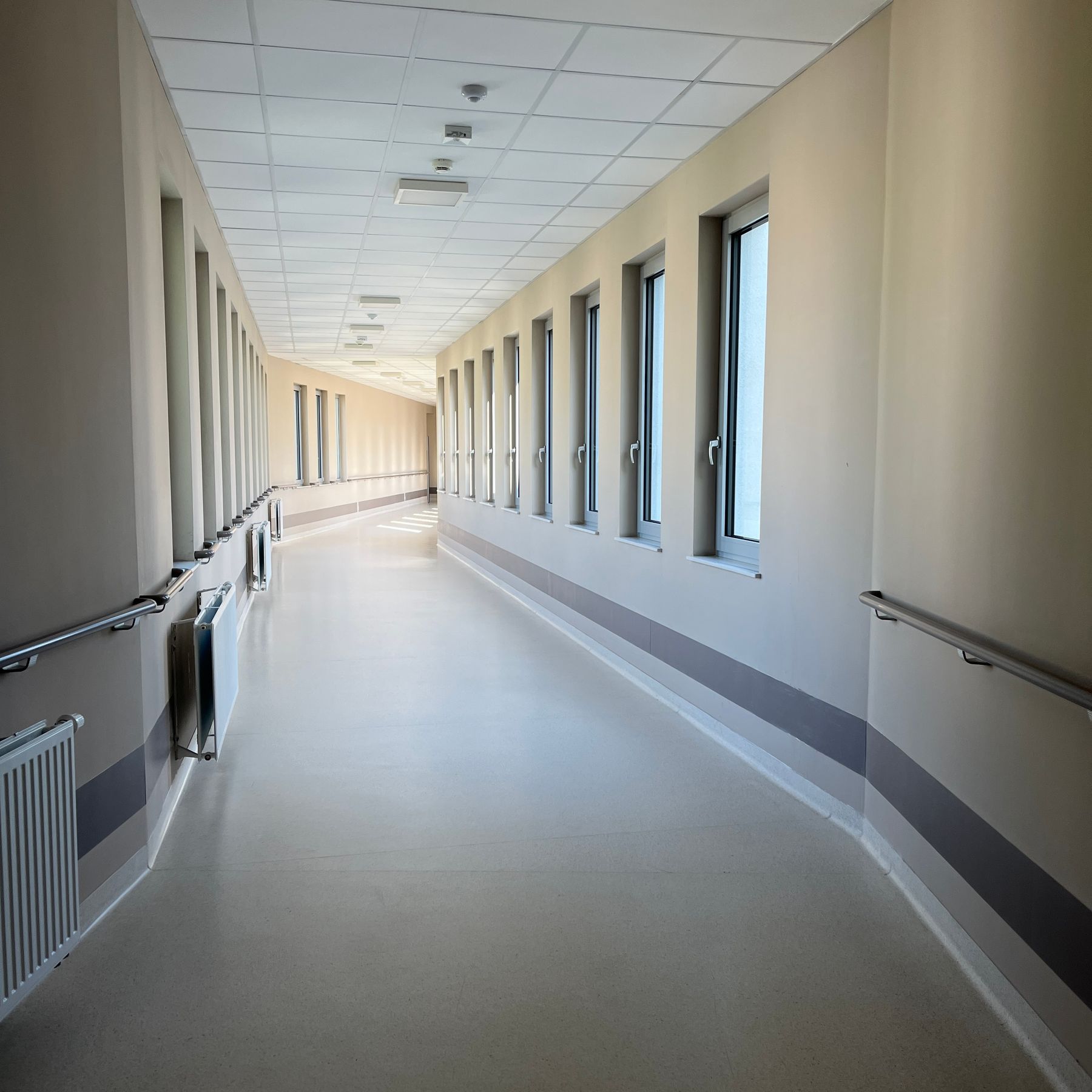 A bright, modern hospital corridor with large windows