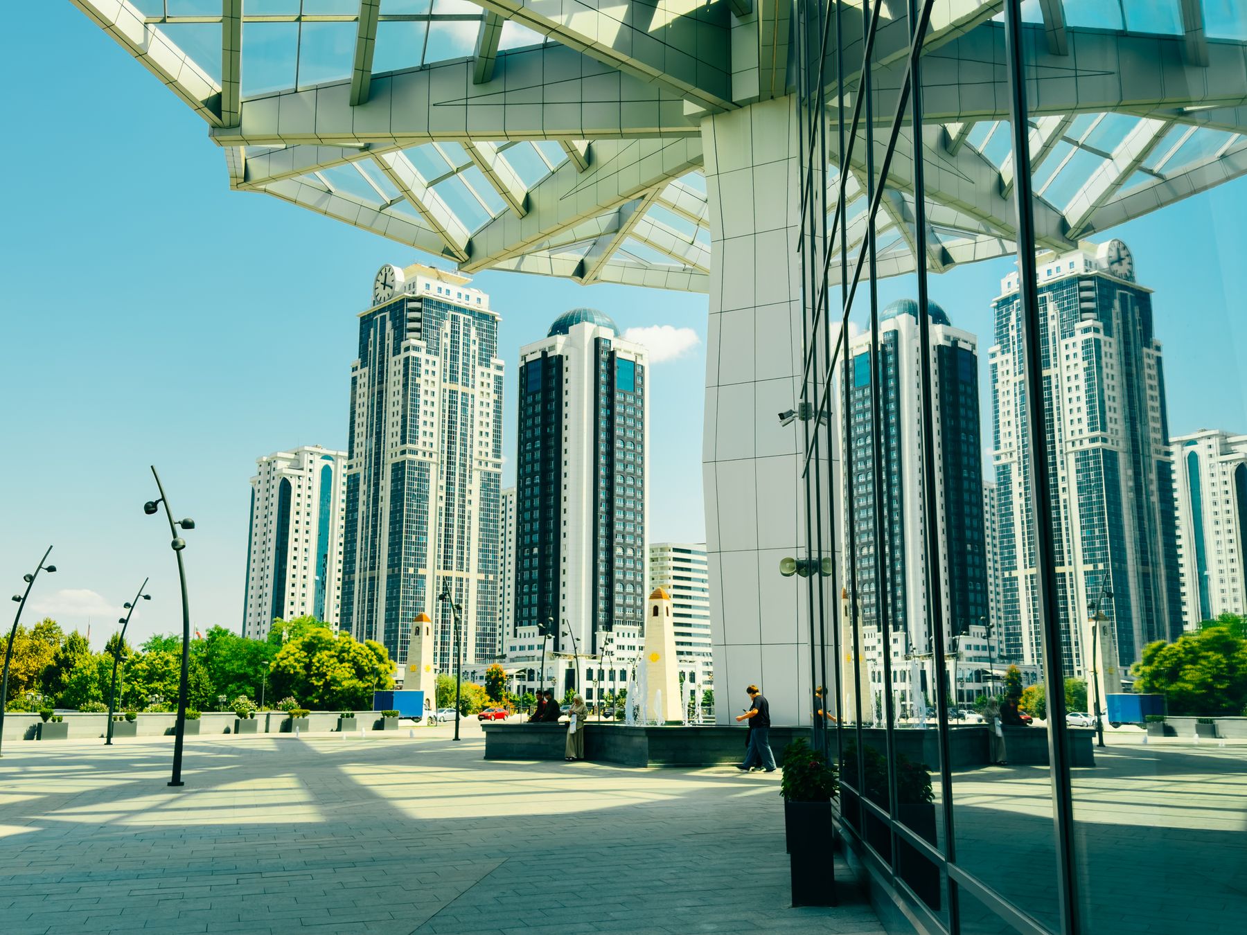 A modern urban skyline reflected in glass towers