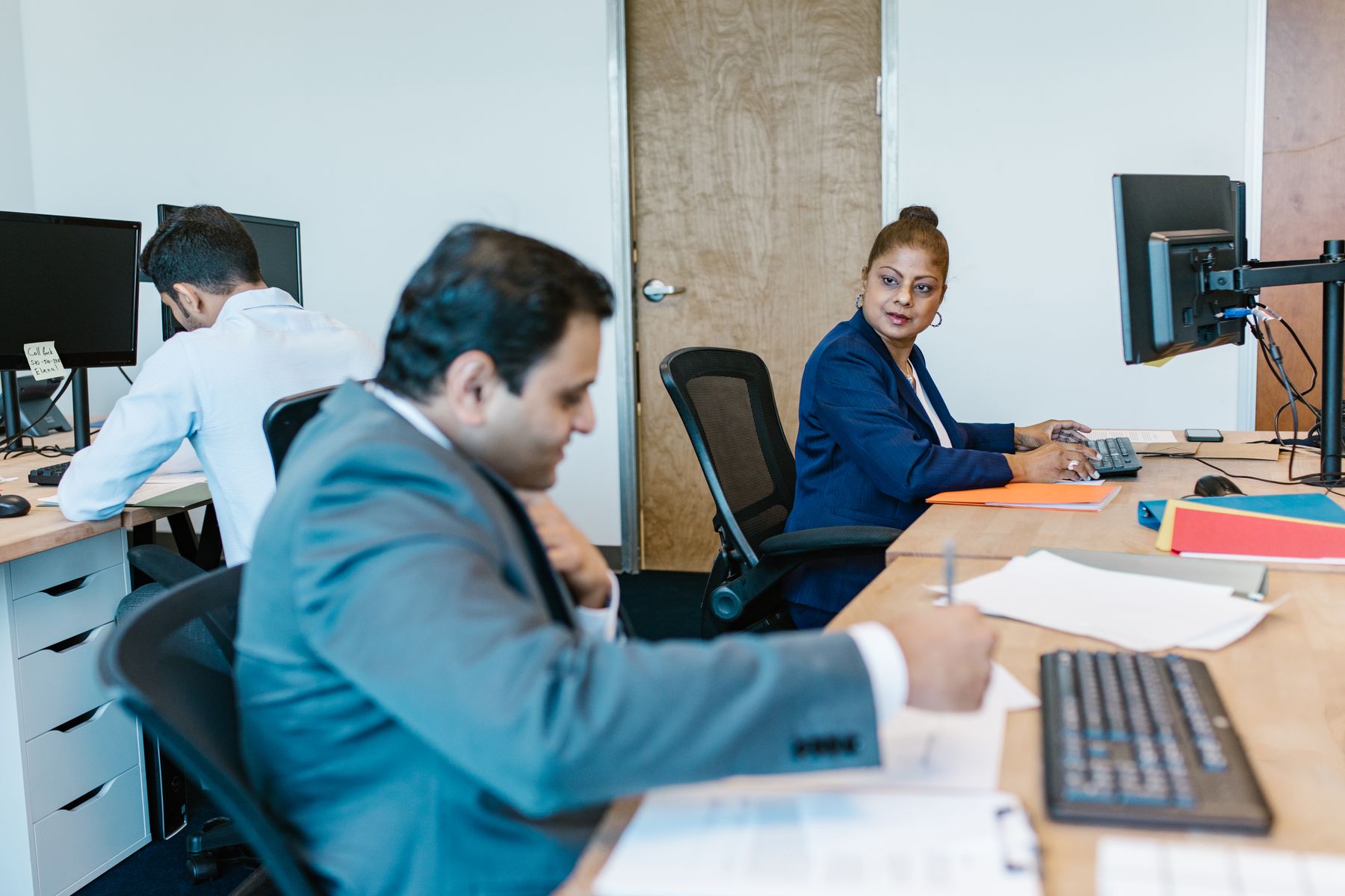 Colleagues working together in an open-plan office