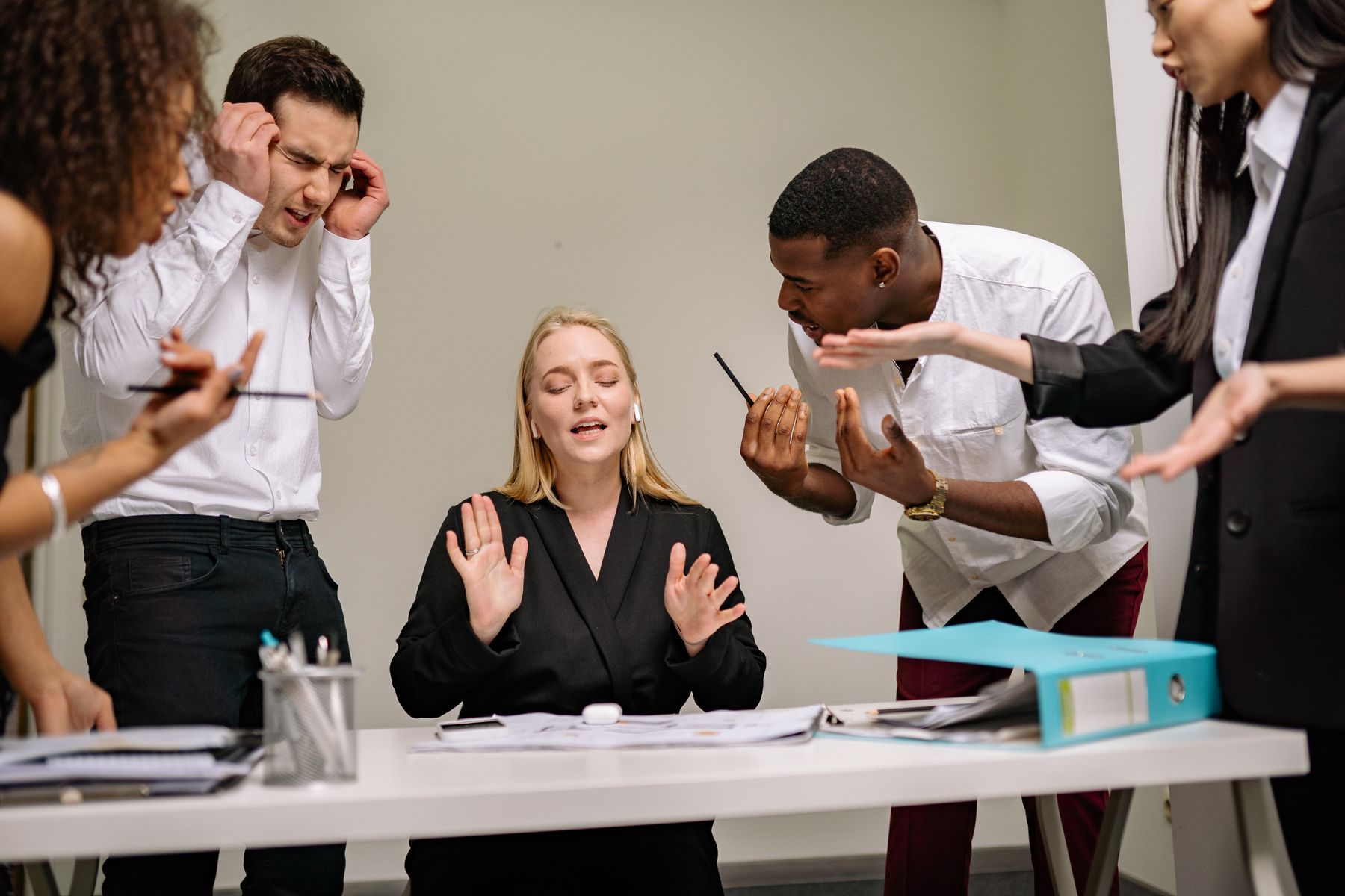 An office team in conversation around a meeting table