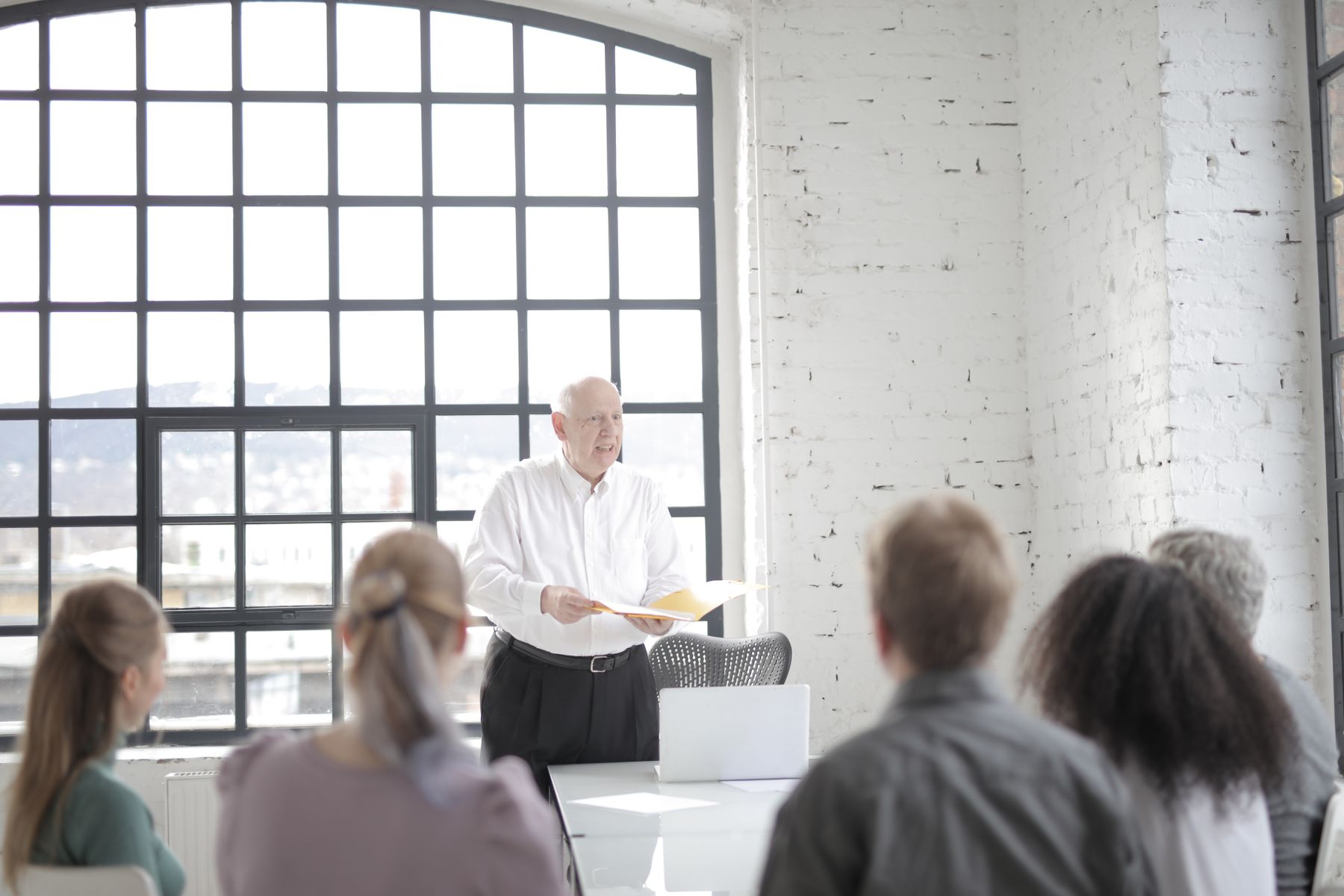 Senior executives listening to a colleague during a boardroom meeting